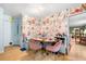 Charming breakfast nook features a built-in bench, floral wallpaper, and stylish pink chairs at 1138 Berkeley Rd, Avondale Estates, GA 30002