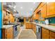 Well-lit kitchen featuring stainless steel appliances, wood cabinets, and a cozy atmosphere at 1138 Berkeley Rd, Avondale Estates, GA 30002
