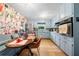 Light blue eat-in kitchen features stainless steel appliances and unique floral wallpaper at 1138 Berkeley Rd, Avondale Estates, GA 30002