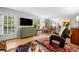 Comfortable living room with hardwood floors, a large window and a wall-mounted TV at 1138 Berkeley Rd, Avondale Estates, GA 30002