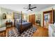 Inviting bedroom with a four-poster bed, hardwood floors, and natural light at 1138 Berkeley Rd, Avondale Estates, GA 30002