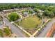 Aerial view of landscaped town green with a circular lawn and walking paths near buildings at 1138 Berkeley Rd, Avondale Estates, GA 30002