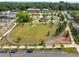 Aerial view of a landscaped town green with walking paths and buildings in the background at 1138 Berkeley Rd, Avondale Estates, GA 30002