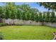 A spacious backyard features lush lawn, a wood fence, and mature trees for added privacy at 1371 N Highland Ne Ave, Atlanta, GA 30306