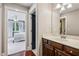 Bathroom featuring a vanity with dark cabinets, a modern sink and hardware and view of the bedroom at 1371 N Highland Ne Ave, Atlanta, GA 30306
