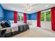 Stylish bedroom with vibrant blue walls, large windows with red curtains, and comfortable furnishings at 1371 N Highland Ne Ave, Atlanta, GA 30306
