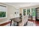 Elegant dining room featuring hardwood floors, neutral colors, and large windows offering lush views at 1371 N Highland Ne Ave, Atlanta, GA 30306