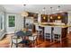Spacious kitchen features dark wood cabinetry, granite countertops, a center island, and stainless steel appliances at 1371 N Highland Ne Ave, Atlanta, GA 30306