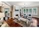 Open-concept living room with fireplace, hardwood floors, and views into the dining area at 1371 N Highland Ne Ave, Atlanta, GA 30306