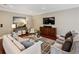 Comfortable living room with stylish furniture, large TV, and hardwood floors at 1371 N Highland Ne Ave, Atlanta, GA 30306
