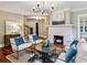 Stylish living room featuring a cozy fireplace, modern decor, hardwood floors, and abundant natural light at 1371 N Highland Ne Ave, Atlanta, GA 30306