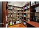 Spacious pantry with dark wood shelving and baskets for organized storage of food items at 1371 N Highland Ne Ave, Atlanta, GA 30306