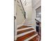 Elegant staircase with hardwood treads, white risers, and wrought iron railings, showcasing architectural detail at 1371 N Highland Ne Ave, Atlanta, GA 30306