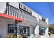 Exterior shot of commercial building Kale Me Crazy, featuring covered entrance, signage and outdoor seating at 1371 N Highland Ne Ave, Atlanta, GA 30306