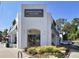 Exterior shot of Morningside Village, featuring a white brick facade, arched entrance, and signage at 1371 N Highland Ne Ave, Atlanta, GA 30306