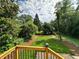A serene backyard with lush green grass, framed by trees, provides a private outdoor retreat at 1766 W Lyle W Ave, College Park, GA 30337
