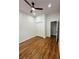 Neutral bedroom features hardwood floors, neutral paint, modern fan, and closet at 1766 W Lyle W Ave, College Park, GA 30337