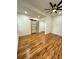 Bright bedroom featuring hardwood floors, a ceiling fan, and a stylish sliding door to the bathroom at 1766 W Lyle W Ave, College Park, GA 30337