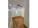 Clean bedroom features hardwood floors, neutral paint, window, and modern ceiling fan at 1766 W Lyle W Ave, College Park, GA 30337