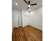 Clean bedroom features hardwood floors, neutral paint, modern fan, and closet at 1766 W Lyle W Ave, College Park, GA 30337