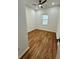 Bright bedroom features hardwood floors, fresh paint, window, and modern ceiling fan at 1766 W Lyle W Ave, College Park, GA 30337