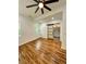 Bright bedroom featuring hardwood floors, a ceiling fan, and a stylish sliding door to the bathroom at 1766 W Lyle W Ave, College Park, GA 30337
