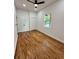 Bright bedroom features hardwood floors, a modern ceiling fan, window, and closet at 1766 W Lyle W Ave, College Park, GA 30337