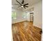 Bright bedroom featuring hardwood floors, a ceiling fan, and a stylish sliding door to the bathroom at 1766 W Lyle W Ave, College Park, GA 30337