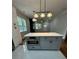 Bright kitchen features a gray island, stainless steel appliances, and hardwood flooring at 1766 W Lyle W Ave, College Park, GA 30337
