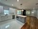 Modern kitchen with white cabinetry, quartz countertops, stainless appliances, and island at 1766 W Lyle W Ave, College Park, GA 30337