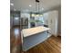 Bright and modern kitchen featuring stainless steel appliances, a quartz island, and stylish lighting at 1766 W Lyle W Ave, College Park, GA 30337
