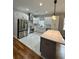 Sleek kitchen with stainless steel appliances, a center island, and modern fixtures at 1766 W Lyle W Ave, College Park, GA 30337