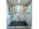 Modern shower with marble tile surround, rainfall showerhead, and black accents at 1766 W Lyle W Ave, College Park, GA 30337