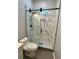 New bathroom shower boasts stylish tile, modern fixtures, and glass door enclosure at 1766 W Lyle W Ave, College Park, GA 30337