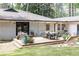 Back deck with outdoor seating and a dining table, great for gatherings and enjoying the view of the backyard at 1443 Fama Ne Dr, Atlanta, GA 30329