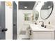 Bright bathroom featuring double sink vanity, modern fixtures, decorative mirrors, and a window for natural light at 1443 Fama Ne Dr, Atlanta, GA 30329