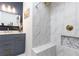 Bathroom featuring a marble vanity with gold fixtures and a tiled shower with a built-in bench at 1443 Fama Ne Dr, Atlanta, GA 30329