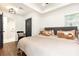 Bright bedroom with a ceiling fan, tray ceiling, large window, and hardwood floors at 1443 Fama Ne Dr, Atlanta, GA 30329