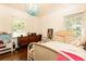 bedroom featuring hardwood floors, a ceiling light, a dresser and a white-painted bed frame at 1443 Fama Ne Dr, Atlanta, GA 30329