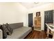 Spare bedroom with wood floors, neutral walls, two closets, and a versatile daybed for guests or relaxation at 1443 Fama Ne Dr, Atlanta, GA 30329
