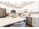 Well-lit kitchen featuring white cabinets, stainless steel appliances, and a spacious island at 1443 Fama Ne Dr, Atlanta, GA 30329