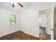 Bedroom features wood floor, a ceiling fan, window, and closet at 1636 Mary George Nw Ave, Atlanta, GA 30318