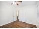 Bedroom with hardwood floors, ceiling fan, closet, and a window providing natural light at 1636 Mary George Nw Ave, Atlanta, GA 30318