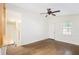 Bright living room features beautiful hardwood floors, ceiling fan, and a large window at 1636 Mary George Nw Ave, Atlanta, GA 30318