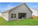 Backyard with green grass and a covered patio featuring a hot tub at 225 Limestone Cir, Conyers, GA 30013