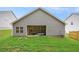 Backyard with green grass and a covered patio featuring a hot tub at 225 Limestone Cir, Conyers, GA 30013