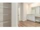 A bathroom featuring a walk in closet and vanity with granite countertops at 225 Limestone Cir, Conyers, GA 30013