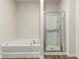 Spacious bathroom with separate tub and shower featuring vinyl plank flooring at 225 Limestone Cir, Conyers, GA 30013