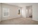Bright bedroom with two windows, neutral carpet and white walls at 225 Limestone Cir, Conyers, GA 30013