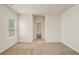A bedroom featuring neutral carpet, white walls, and a view into the bathroom at 225 Limestone Cir, Conyers, GA 30013